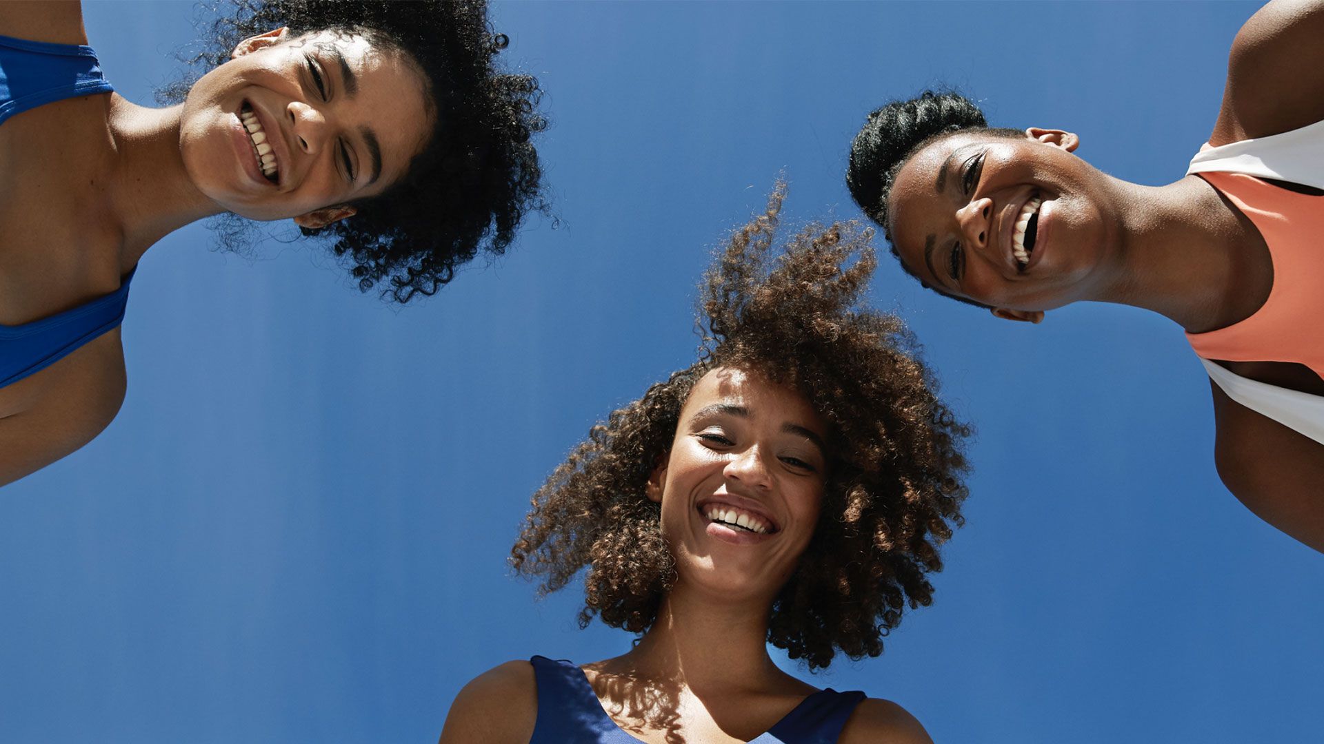 3 people looking down at the camera 