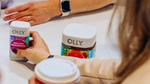 Person reaching for OLLY products