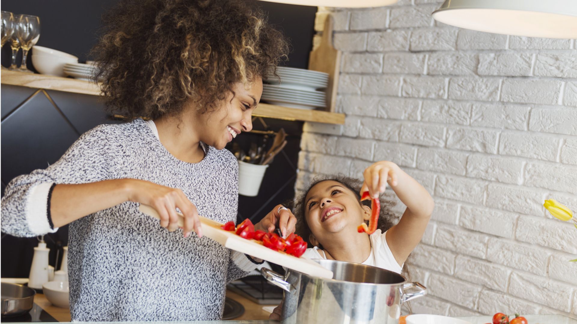 Mom and daughter making dinner in the kitchen