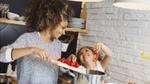 Mom and daughter making dinner in the kitchen
