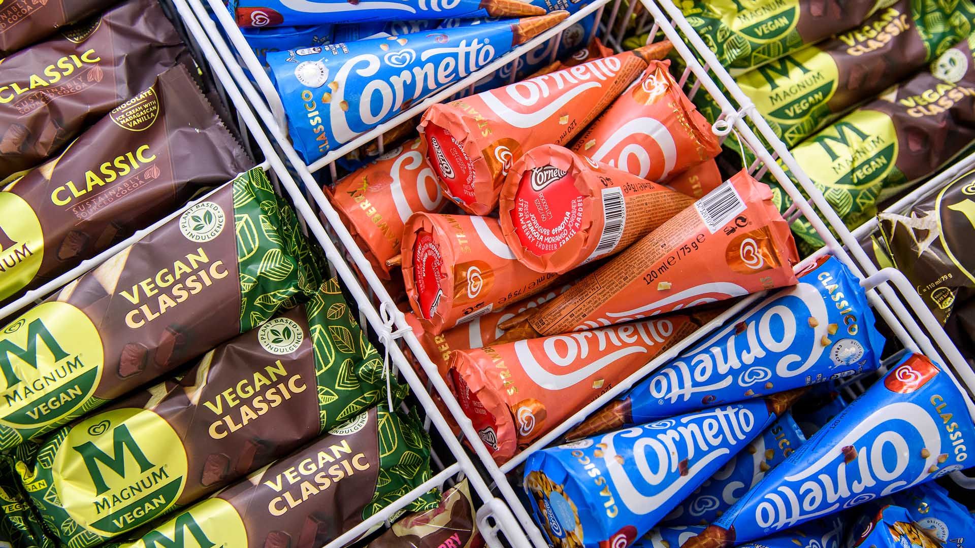 Overhead view of various Magnum and Cornetto ice creams in a freezer cabinet.