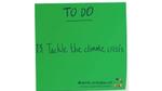 Green sticky note with Tackle the climate crisis written on it