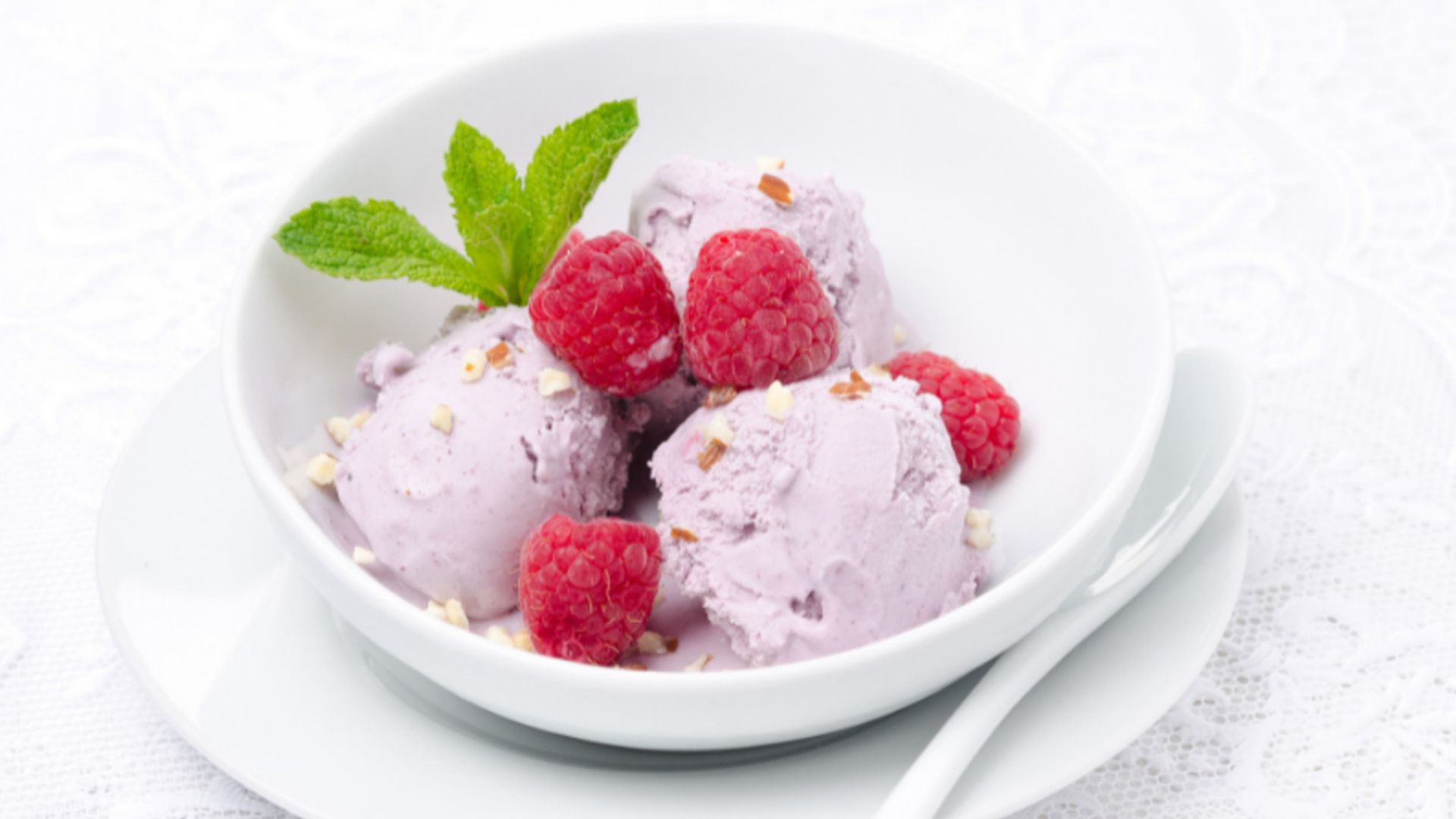 Dish of ice cream with raspberries