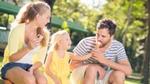 Woman, man and child eating ice cream outside