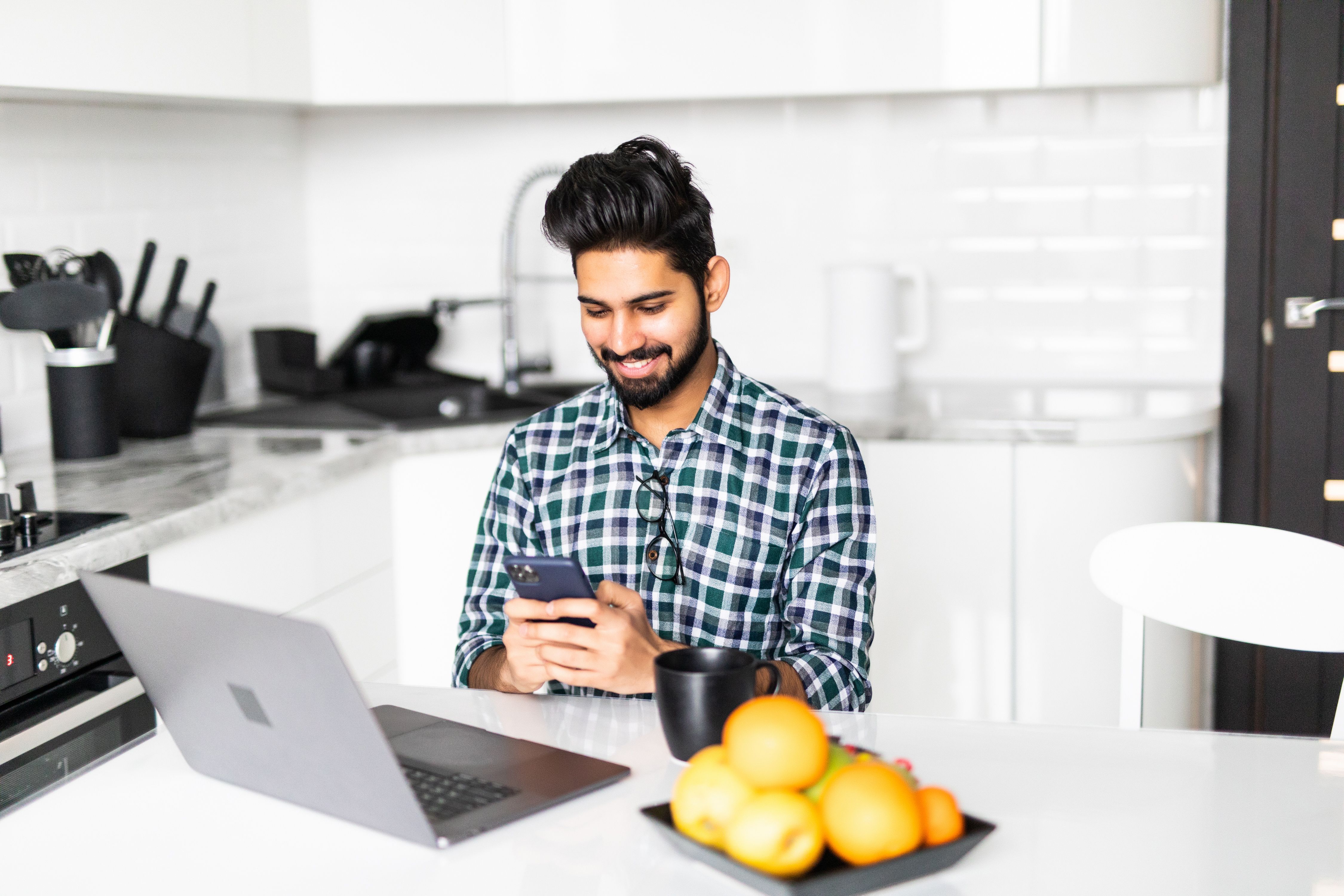 Man with a phone and laptop